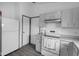 Kitchen with white refrigerator and range with gray countertops and cabinets with stainless steel hardware at 6707 Greendale Ln, Indianapolis, IN 46241