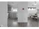 View of the kitchen with wood-look flooring, neutral cabinets and countertops, and open to the dining area at 6707 Greendale Ln, Indianapolis, IN 46241