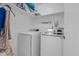 Efficient laundry room featuring a washer, dryer, shelf storage, and laundry-themed wall decor at 6707 Greendale Ln, Indianapolis, IN 46241