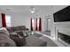 Bright living room featuring a fireplace, a gray sectional sofa, and hardwood floors at 6707 Greendale Ln, Indianapolis, IN 46241