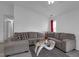 Spacious living room with neutral-toned sectional, glass coffee table, and hardwood floors at 6707 Greendale Ln, Indianapolis, IN 46241