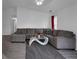 Open-concept living room featuring a neutral color palette, hardwood floors, and a large sectional sofa at 6707 Greendale Ln, Indianapolis, IN 46241
