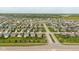Aerial view of a house in a neighborhood with green landscaping and close proximity to community park at 695 Bobtail Dr, Greenfield, IN 46140