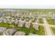 Aerial view of a home with green landscaping, fenced backyard, and neighborhood with pond at 695 Bobtail Dr, Greenfield, IN 46140