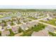 Aerial view of a home in a suburban neighborhood near a pond and lush green landscaping at 695 Bobtail Dr, Greenfield, IN 46140