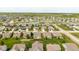 Aerial view of a home with a fenced yard, green grass, landscaping, and well-maintained neighborhood at 695 Bobtail Dr, Greenfield, IN 46140