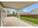 Enjoy outdoor living on this covered back patio overlooking a well-maintained lawn at 695 Bobtail Dr, Greenfield, IN 46140