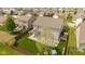 A well-maintained backyard with green grass, a covered patio, and wood fence at 695 Bobtail Dr, Greenfield, IN 46140