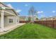Spacious backyard with lush green grass, mature trees, and a fenced perimeter at 695 Bobtail Dr, Greenfield, IN 46140