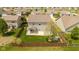 Aerial view of the backyard with green grass, landscaping, privacy fence, and patio at 695 Bobtail Dr, Greenfield, IN 46140