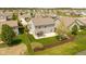 Aerial view of a backyard featuring a patio, privacy fence, green grass, and landscaping at 695 Bobtail Dr, Greenfield, IN 46140