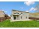 Large backyard featuring a patio area, green lawn, and privacy fencing at 695 Bobtail Dr, Greenfield, IN 46140