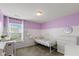 Bright bedroom with half-purple walls, ceiling fan, carpet floor, and closet at 695 Bobtail Dr, Greenfield, IN 46140