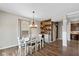 Cozy dining room with stylish lighting fixture, wood accent wall, and ample natural light at 695 Bobtail Dr, Greenfield, IN 46140