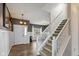 Welcoming entryway featuring hardwood floors, a staircase with white railings, and a front door with sidelights at 695 Bobtail Dr, Greenfield, IN 46140
