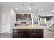Modern kitchen featuring an island with a sink, stainless steel appliances, dark wood cabinetry, and granite countertops at 695 Bobtail Dr, Greenfield, IN 46140