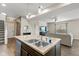 Open-concept kitchen featuring granite countertops, stainless steel sink, and modern pendant lighting at 695 Bobtail Dr, Greenfield, IN 46140