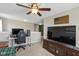Open-concept living room features a large television, a comfortable seating area, and a ceiling fan at 695 Bobtail Dr, Greenfield, IN 46140
