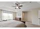 This bedroom has neutral walls, carpet floors, ceiling fan, and lots of natural light at 695 Bobtail Dr, Greenfield, IN 46140