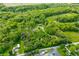 Serene aerial perspective highlighting the property's wooded landscape and peaceful rural setting at 6968 S 300 W, Trafalgar, IN 46181