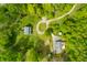 This bird's-eye view highlights the property's secluded location surrounded by dense greenery and outbuildings at 6968 S 300 W, Trafalgar, IN 46181