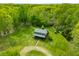 An aerial view of a home nestled among lush trees surrounded by vibrant greenery at 6968 S 300 W, Trafalgar, IN 46181