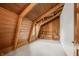 Attic room with wood-beam ceiling, built-in shelves, natural light from the window, and door at 6968 S 300 W, Trafalgar, IN 46181