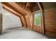 Attic room with wood-beam ceiling, natural light from the window, and door at 6968 S 300 W, Trafalgar, IN 46181