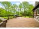 Spacious wooden deck, perfect for outdoor entertaining with a grill and built-in seating area at 6968 S 300 W, Trafalgar, IN 46181