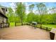 Large outdoor deck featuring a grill and built-in seating, ideal for relaxing and enjoying the surrounding nature at 6968 S 300 W, Trafalgar, IN 46181