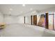 Spacious finished basement featuring carpeted floors, rustic support beams, and access to the upper level at 6968 S 300 W, Trafalgar, IN 46181