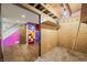 Unfinished basement space with plywood walls and colorful adjoining finished room with stairs at 6968 S 300 W, Trafalgar, IN 46181
