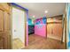 Finished basement area with colorful accents, wood-look flooring, and a convenient half bathroom at 6968 S 300 W, Trafalgar, IN 46181