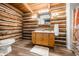 Rustic bathroom featuring a wooden vanity, log walls, and modern fixtures at 6968 S 300 W, Trafalgar, IN 46181