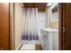 Bathroom featuring shower with patterned curtain, white vanity, and decorative details at 6968 S 300 W, Trafalgar, IN 46181