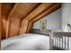 Bedroom with wood-beam ceiling, gray accent wall, and bright window showcasing a comforting space at 6968 S 300 W, Trafalgar, IN 46181