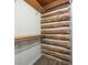 Walk-in closet with wooden shelving and log walls at 6968 S 300 W, Trafalgar, IN 46181