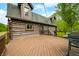 Expansive wooden deck featuring a gas grill, perfect for outdoor entertaining, with scenic views of the surrounding lush greenery at 6968 S 300 W, Trafalgar, IN 46181