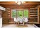 Charming dining area with log walls and bay window featuring a lovely view of the trees at 6968 S 300 W, Trafalgar, IN 46181
