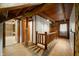 Upstairs hallway with a wooden railing, exposed beams, and natural light at 6968 S 300 W, Trafalgar, IN 46181