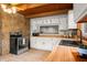 Bright kitchen featuring stone accent wall, sleek appliances, and ample counter space at 6968 S 300 W, Trafalgar, IN 46181