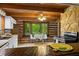 Charming kitchen with white cabinets, wood countertops, natural light, and rustic wood walls at 6968 S 300 W, Trafalgar, IN 46181