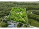 Aerial view outlines property lines of a tree-covered estate with a house, outbuildings, and driveway at 6968 S 300 W, Trafalgar, IN 46181