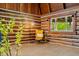 Comfortable living room with log walls, a cozy reading chair, and natural light at 6968 S 300 W, Trafalgar, IN 46181