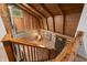 Unique living room featuring wood beams, log walls, and front door with chair situated in the corner at 6968 S 300 W, Trafalgar, IN 46181