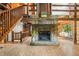 Cozy living room with stone fireplace, wood floors, and a staircase leading to the upper level at 6968 S 300 W, Trafalgar, IN 46181