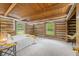 Spacious main bedroom with wood beam ceiling, log walls, and carpeted floors at 6968 S 300 W, Trafalgar, IN 46181