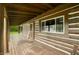 Charming front porch with wood accents, creating a welcoming entrance with a 'Hello' doormat at 6968 S 300 W, Trafalgar, IN 46181