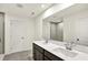 Bathroom featuring a double sink vanity, tile flooring, and a glass-enclosed shower at 7132 Sterling Way, Brownsburg, IN 46112