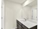 This bathroom features a large mirror, toilet and sink with dark wood vanity at 7132 Sterling Way, Brownsburg, IN 46112